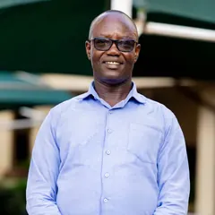 Portrait of a smiling man in glasses and a light blue shirt