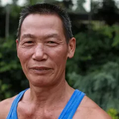Portrait of a man in a blue tank top outdoors